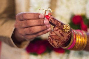 Punjabi couple hands holding rings